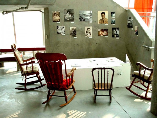 The Lumbee Legends books on a table and photos of family members featured in the project on a wall.