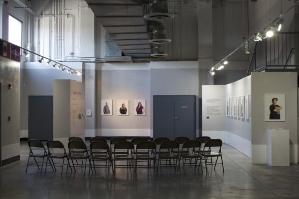 The Exquisite Lumbees and Hard Workin' Pilgrims exhibit; photos on walls.