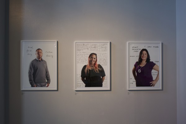 The Exquisite Lumbees and Hard Workin' Pilgrims exhibit; photos on walls.