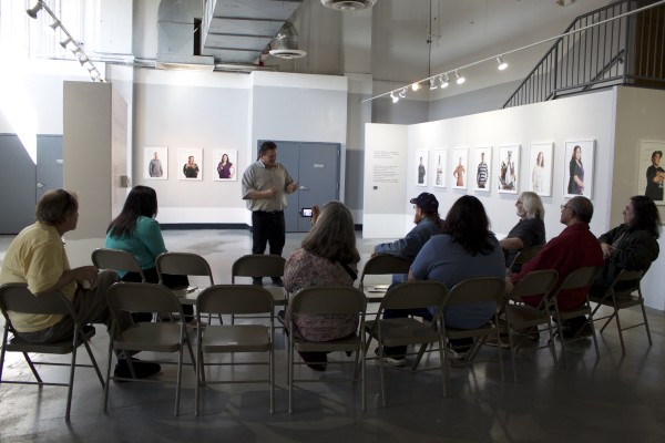 People viewing the Exquisite Lumbees and Hard Workin' Pilgrims exhibit.
