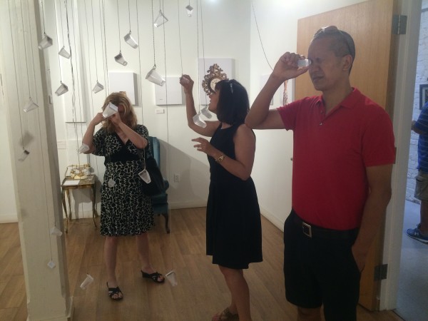 Attendees viewing the objects in the installation.