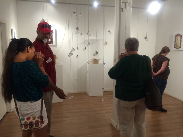 Attendees viewing the objects in the installation.