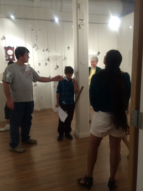 Attendees viewing the objects in the installation.