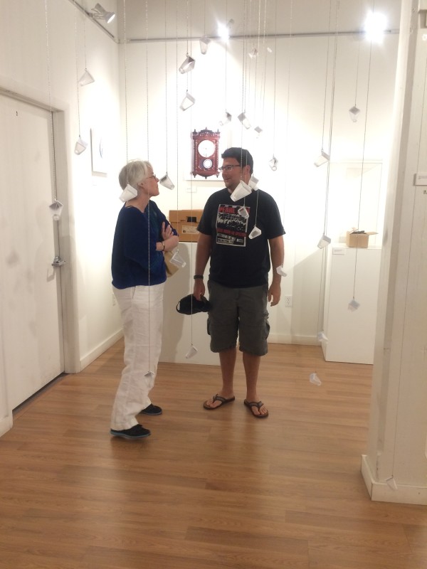 Attendees viewing the objects in the installation.