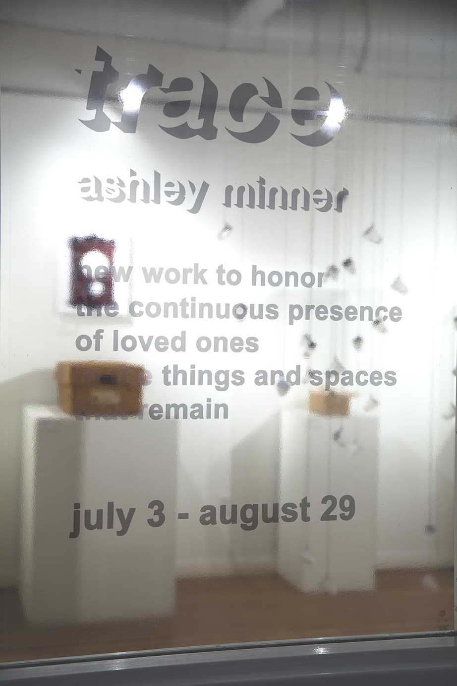 The event title sign on a glass panel.