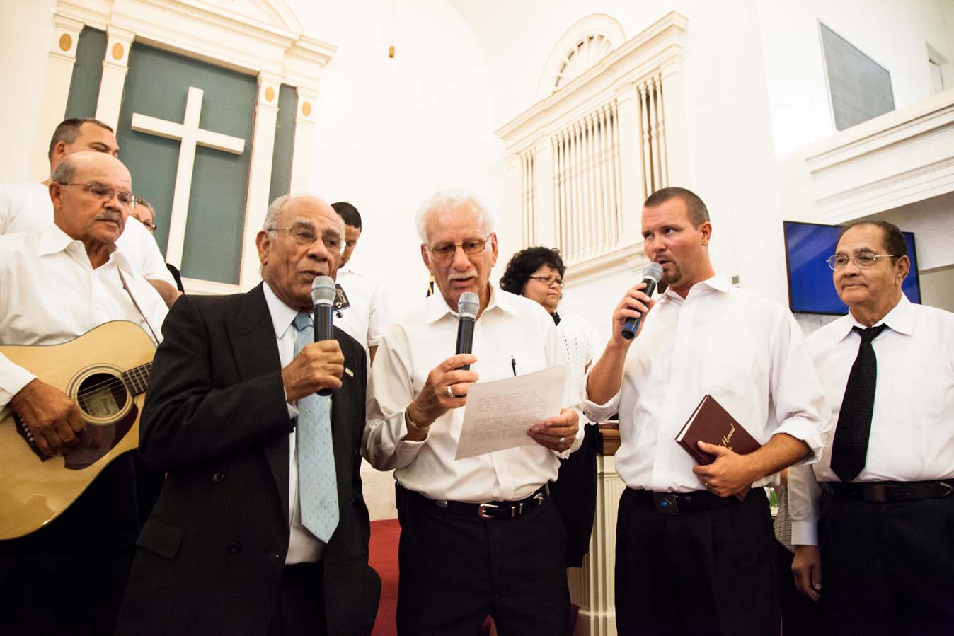 Performers singing and playing the guitar.
