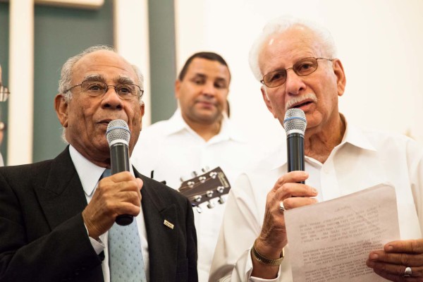 Performers singing and playing the guitar.