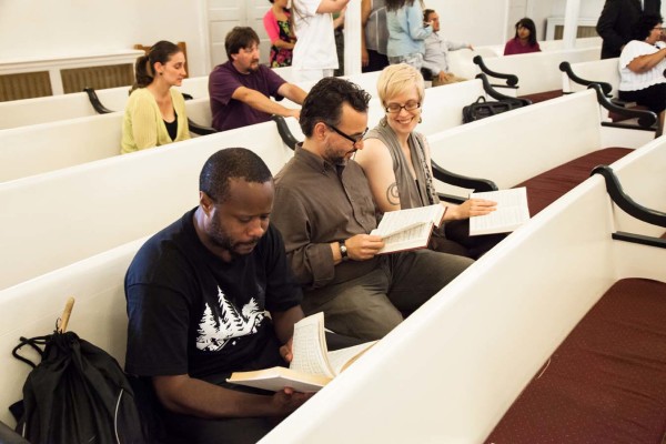 Audience members reading along and smiling.