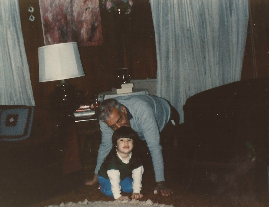 Ashley Minner as a child, sitting with her father.