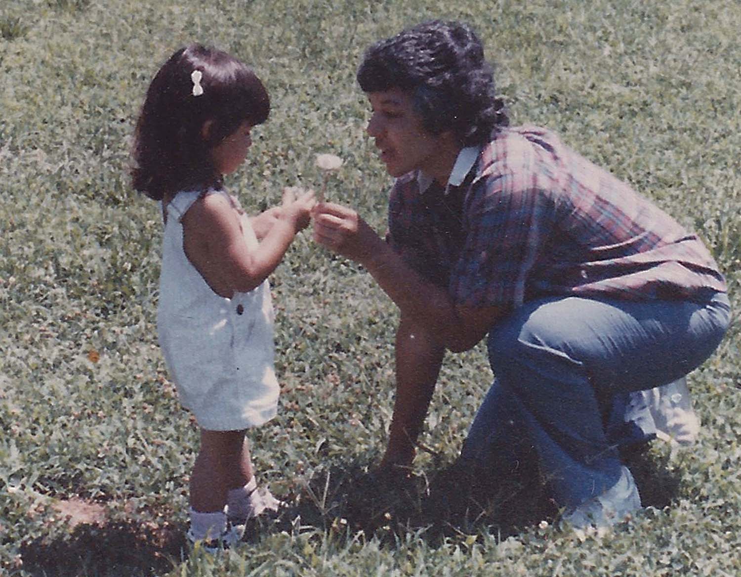 Ashley Minner as a child, being handed a flower.