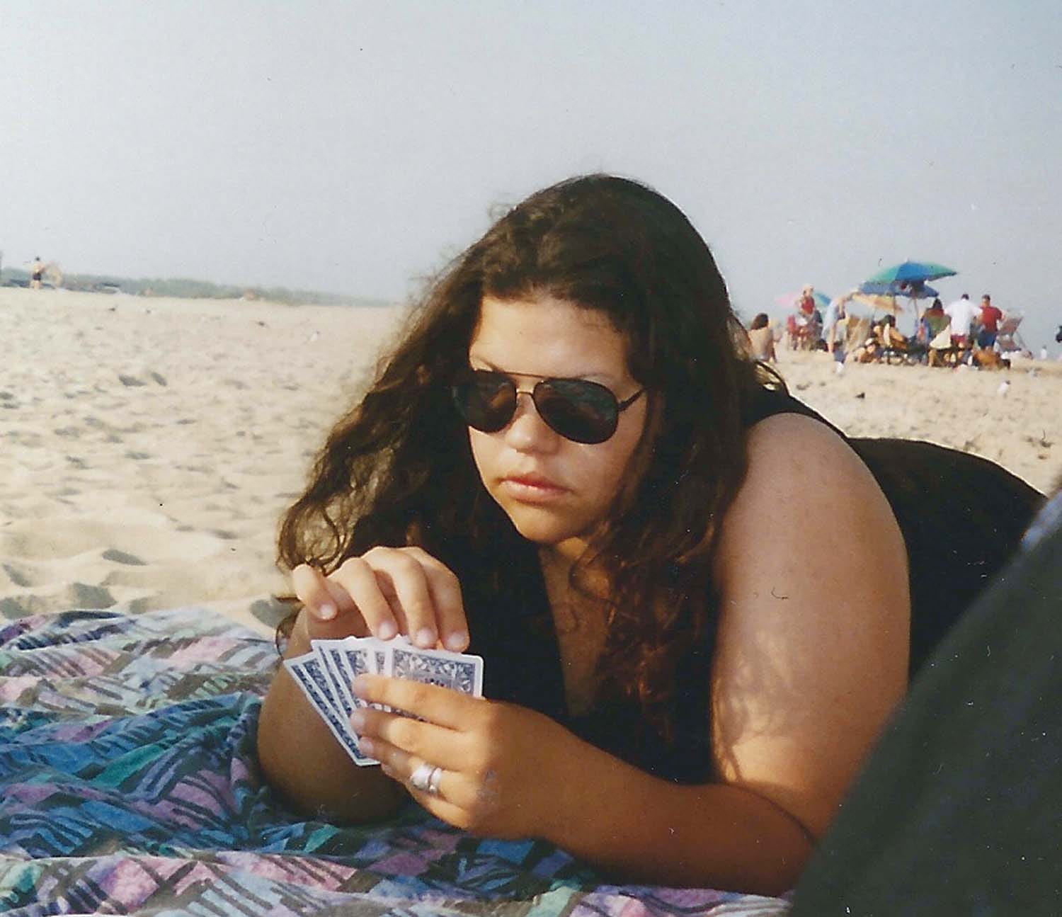 Ashley Minner playing cards on the beach.